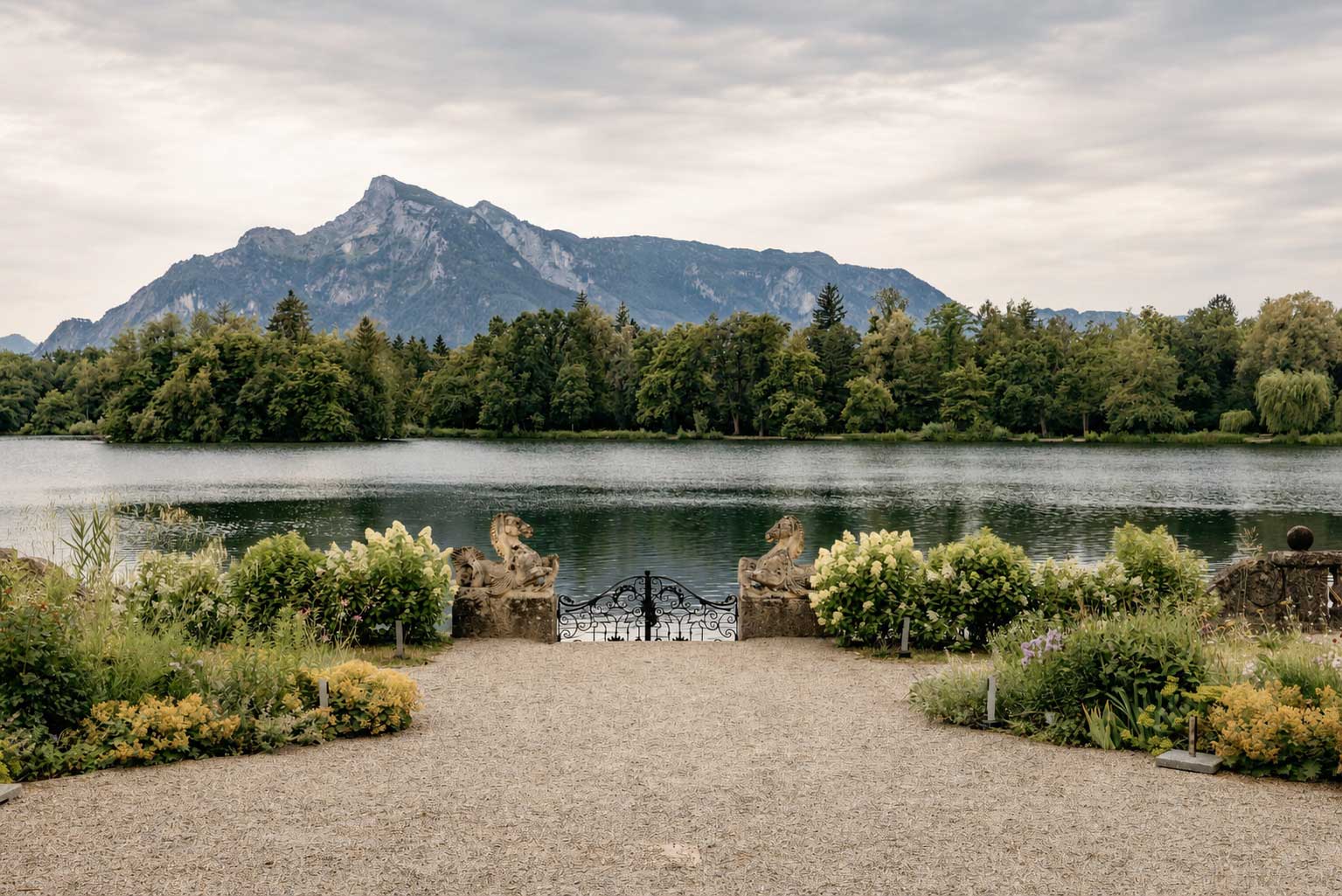 Historic gardens of Leopoldskron Palace overlooking Leopoldskron Lake, one of Salzburg's famous The Sound of Music filming locations.