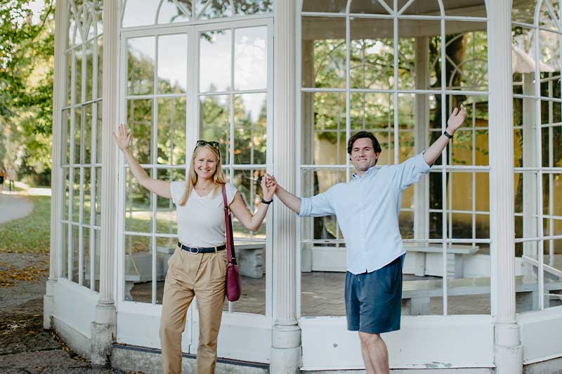 Couple posing in front of the original Sound of Music Pavilion in Hellbrunn, Salzburg