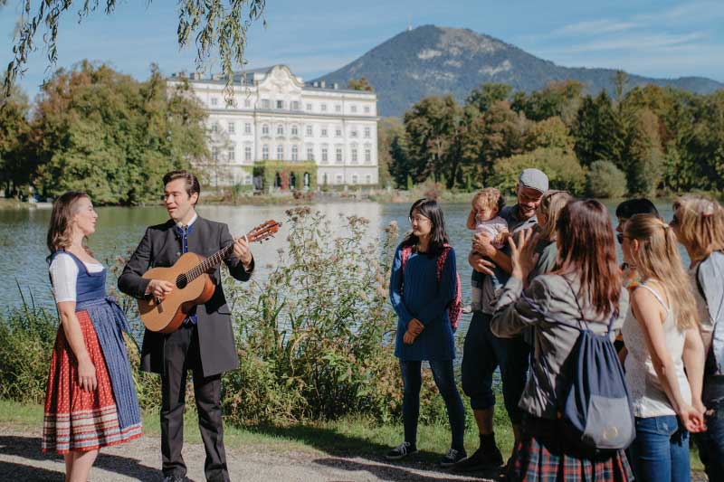 Guests enjoy a live Sound of Music Salzburg Tour performance at Leopoldskron Palace filming location