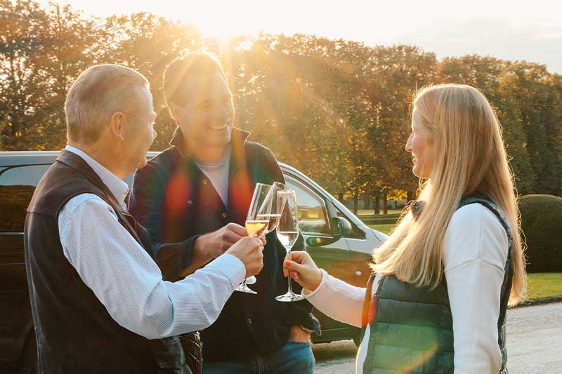 Luxury tourism Salzburg – close-up of guests toasting during a private weTours experience at sunset.