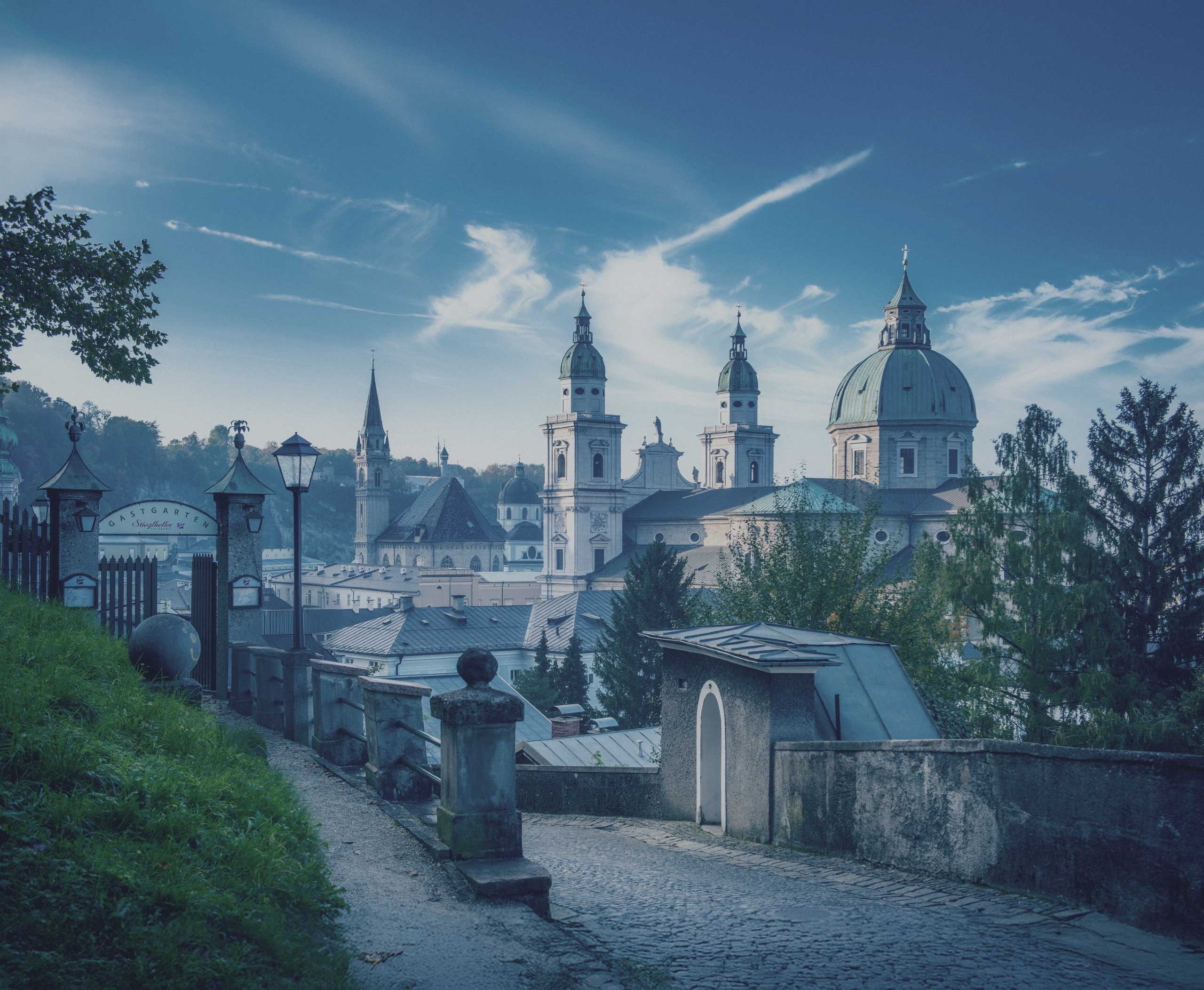 Deep blue architectural view of Salzburg with cathedral towers, used as cover image for weTours Terms and Conditions.