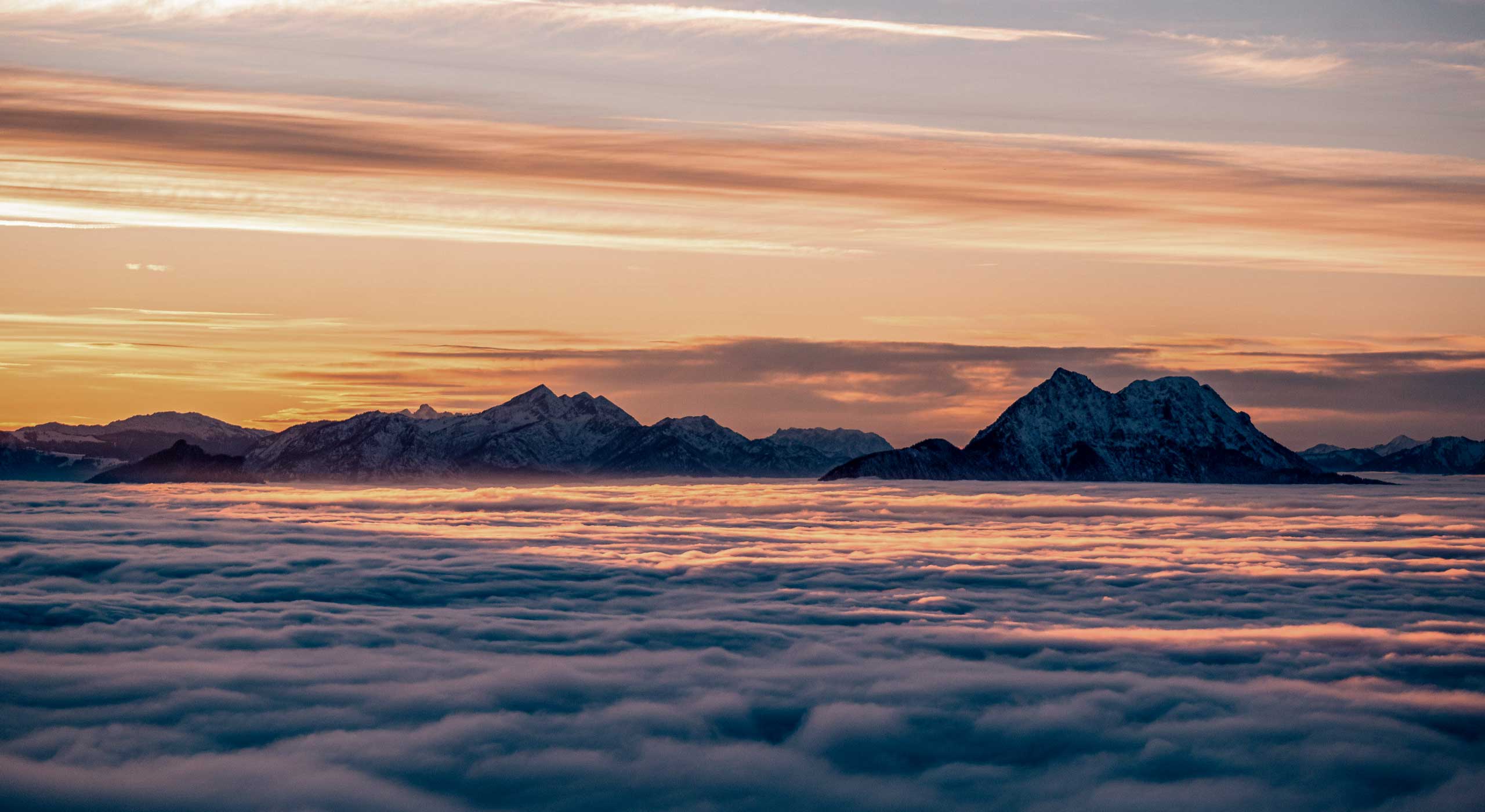 Panoramic sunset view over Salzburg and the Bavarian Alps from Gaisberg above a sea of clouds
