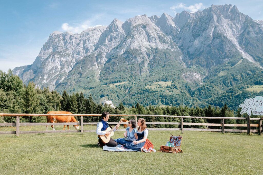 Sound of Music Trail in Werfen with guests enjoying a meadow picnic and alpine scenery during the Private Sound of Maria Tour City & Meadow Escape and Ultimate Experience